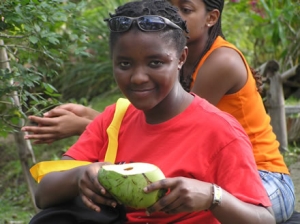 student offering fresh picked fruit