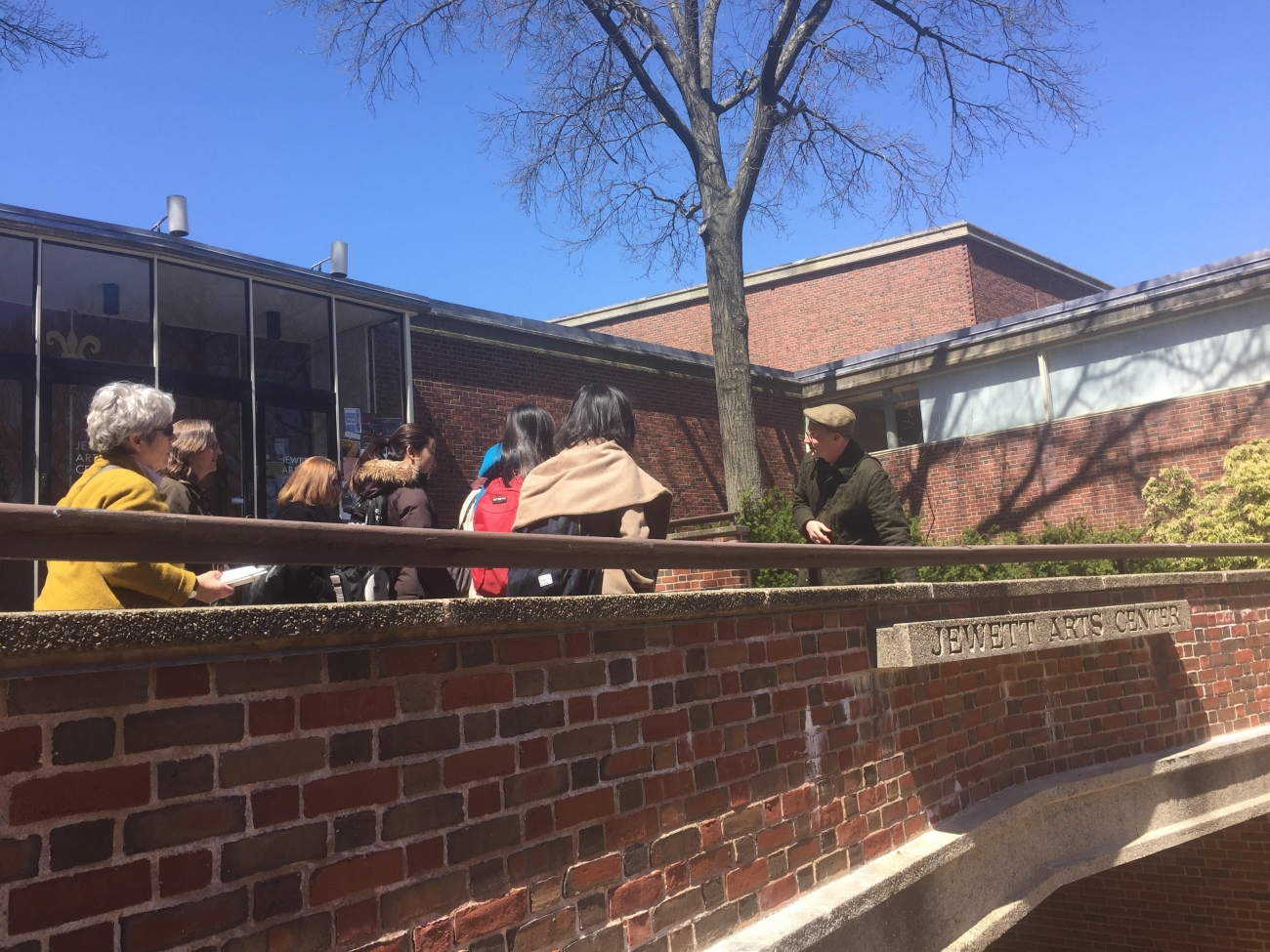 exterior image of the Jewett Arts Center with Professor Friedman and students visible