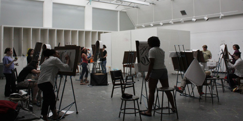 students drawing on easels in studio classroom