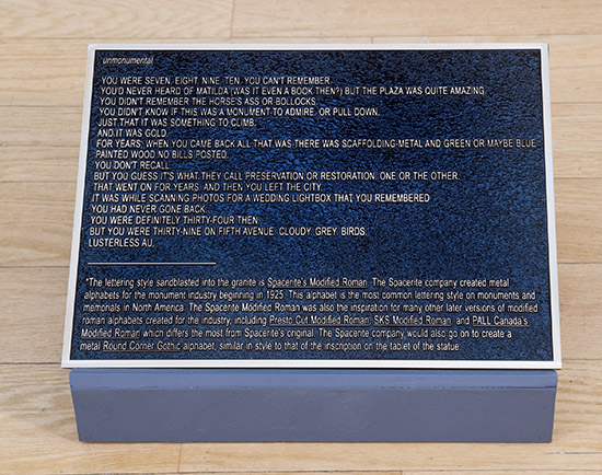 traditional bronze monument plaque with a poem on it
