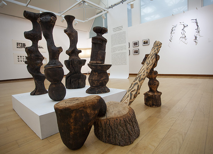low view of an arrangement of stained and carved wood forms
