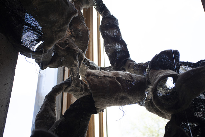close-up on part of a complex hanging burlap sculpture