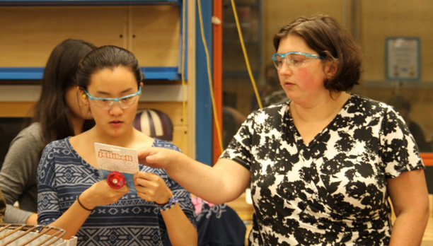 Amy Banzaert instructs a student in the lab 