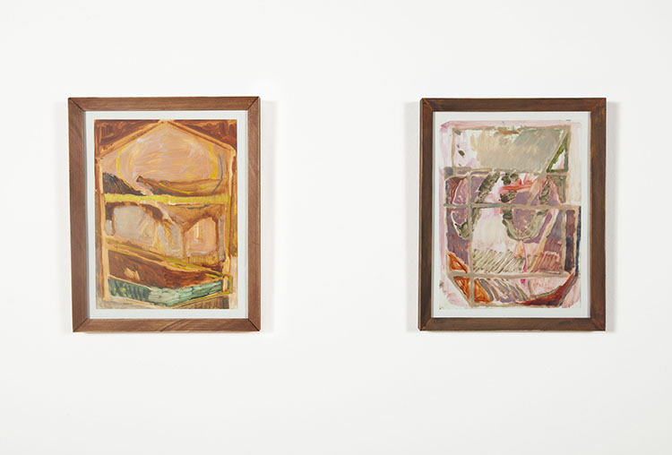 two abstract works on paper in wood frames on a white wall