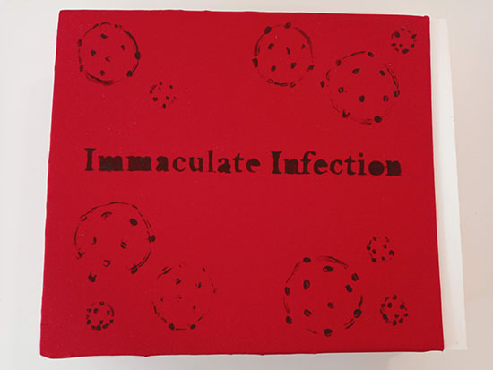 artist book with red cover, black text reading IMMACULATE INFECTION with brushy black circles with dots