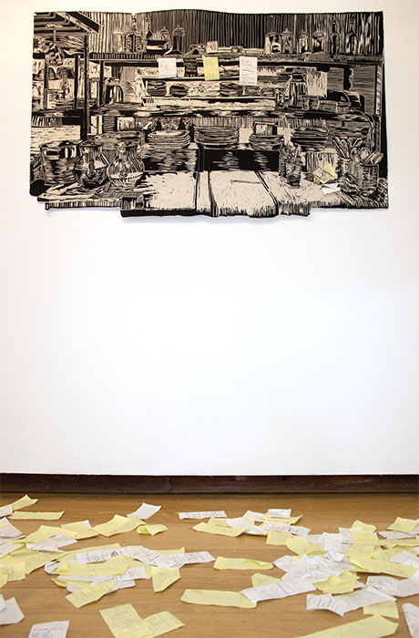 large black and white woodcut print of cafe scene with 3 receipts attached, paper receipts on the floor in front of it