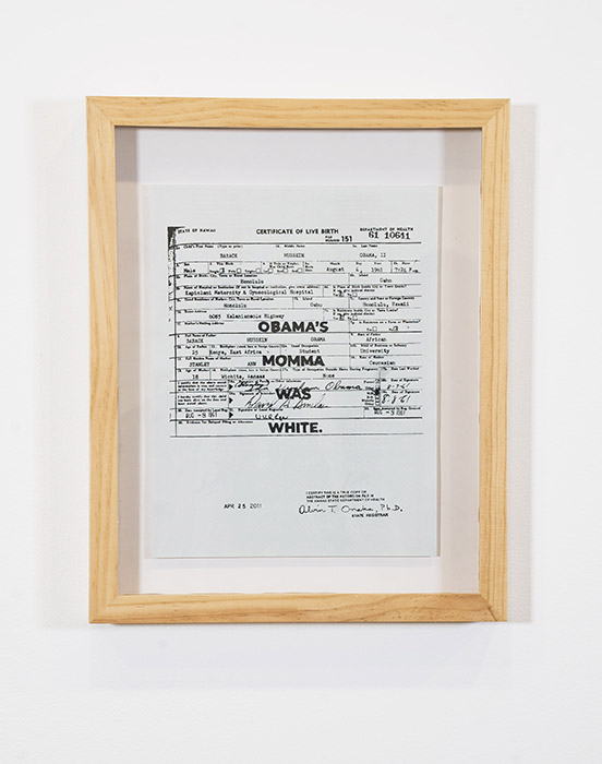 wood-framed birth certificate with the words 'OBAMA'S MOMMA WAS WHITE.' printed on top
