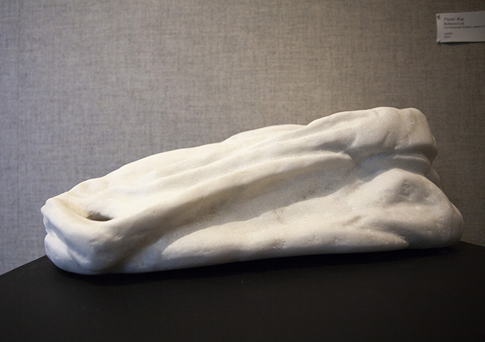 side view of a white marble sculpture of a plastic bag