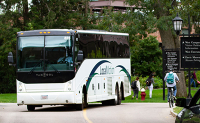 A bus filled with students outside of the Lulu Campus Center